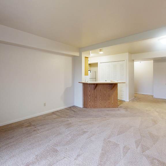 Thumbnail 7 of 13 A living and dining room with a carpeted floor at Gull Prairie/Gull Run Apartments and Townhomes in Kalamazoo, MI