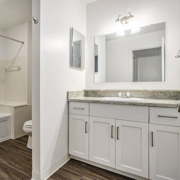 Thumbnail 21 of 28 a bathroom with white cabinets and a whirlpool tub at Gull Prairie/Gull Run Apartments and Townhomes, Kalamazoo, Michigan