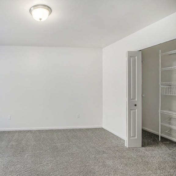 Thumbnail 15 of 28 bedroom with a closet with wardrobe organizers at Gull Prairie/Gull Run Apartments and Townhomes, Kalamazoo, Michigan