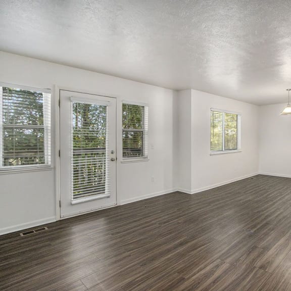 Thumbnail 4 of 28 an empty living room with a hard surface floor at Gull Prairie/Gull Run Apartments and Townhomes, Kalamazoo, MI