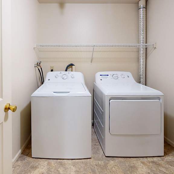 Thumbnail 6 of 12 A laundry room with a full size washer and dryer at Gull Prairie/Gull Run Apartments and Townhomes, Kalamazoo, MI, 49048