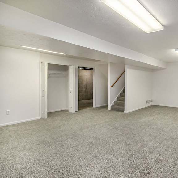 Thumbnail 14 of 15 A finished basement recreation room with a storage area  at Gull Prairie/Gull Run Apartments and Townhomes, Michigan, 49048