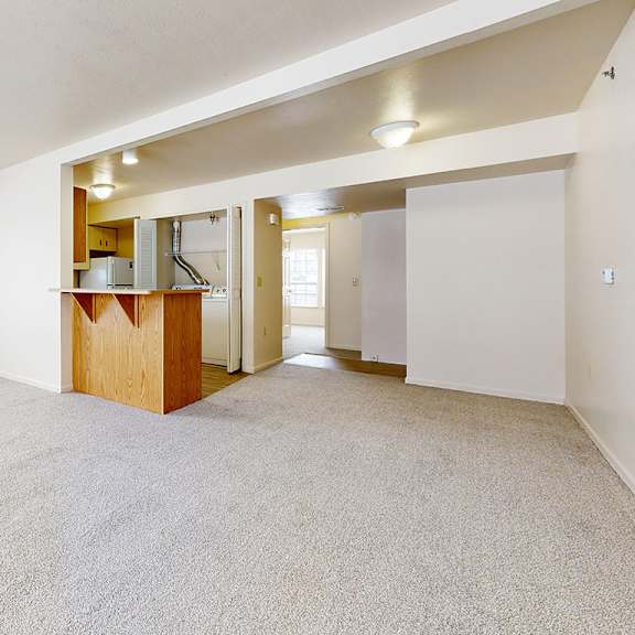 Thumbnail 4 of 8 An end style living room with a carpeted floor and a large window at Gull Prairie/Gull Run Apartments and Townhomes, Kalamazoo, 49048
