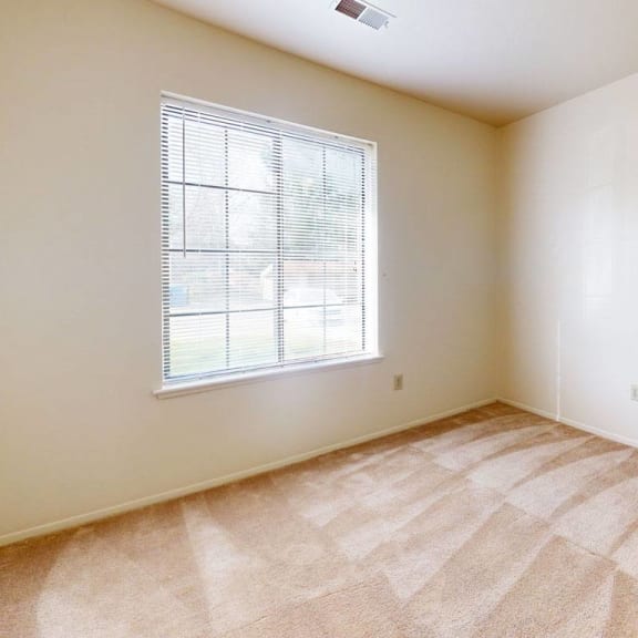 Thumbnail 14 of 14 an empty room with a window  at Hampton Lakes Apartments in Walker, MI 49534