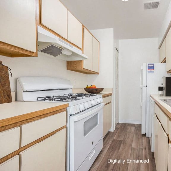 Thumbnail 8 of 14 a kitchen with a gas stove, dishwasher, and refrigerator at Hampton Lakes Apartments, Michigan, 49534
