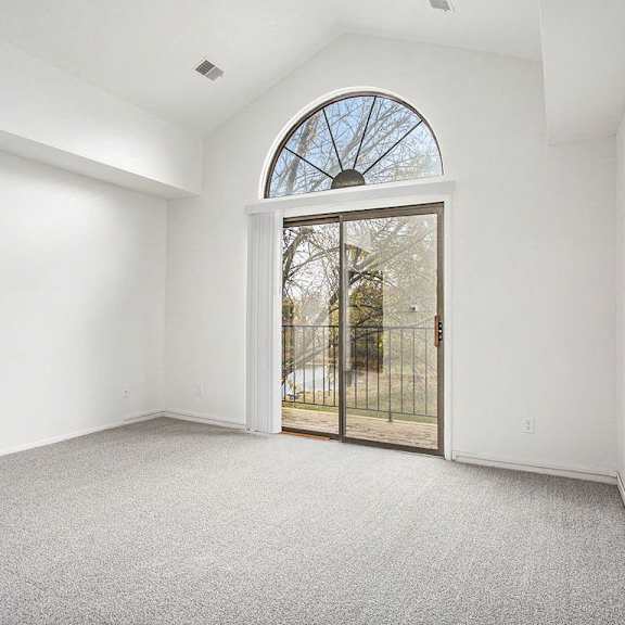 Thumbnail 4 of 15 an empty living room with a cathedral ceiling at Hampton Lakes Apartments, Michigan, 49534