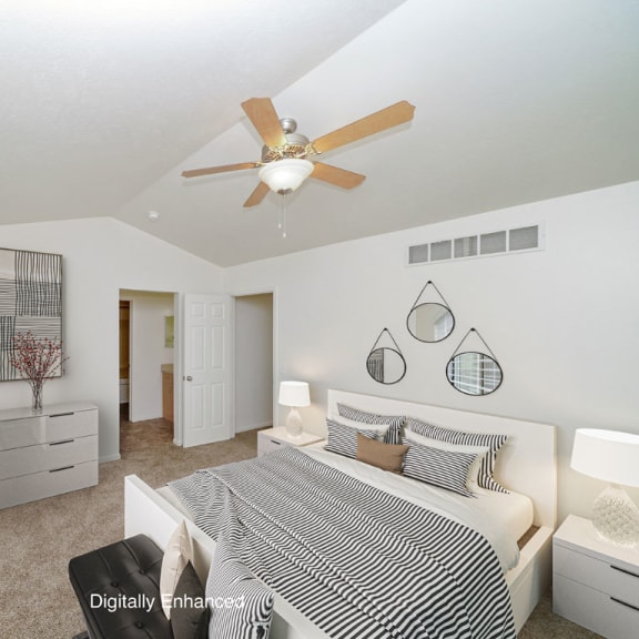 Thumbnail 13 of 15 a bedroom with a vaulted ceiling and ceiling fan at Foxwood and The Hermitage, Portage, MI, 49024