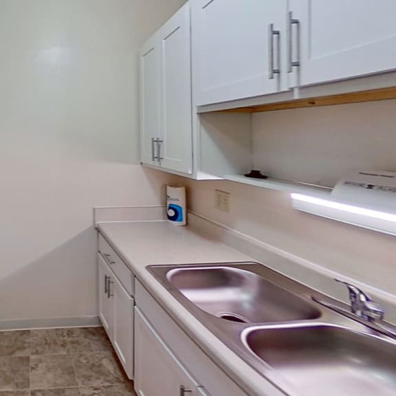 Thumbnail 7 of 10 upgraded kitchen with white cabinets at Briarwood Apartments, Benton Harbor, 49022