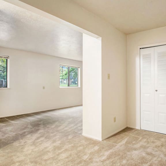 Thumbnail 9 of 9 an empty living room with a closet and a door at Hickory Village Apartments, Mishawaka, IN