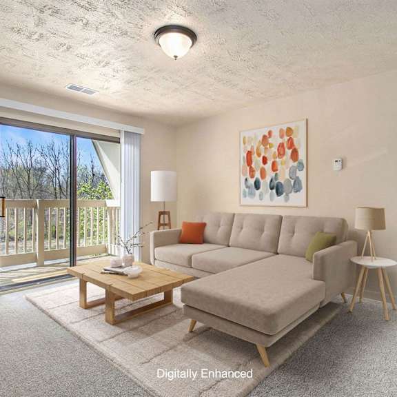 Thumbnail 3 of 11 a living room with a couch and a slider to a balcony at Hickory Village Apartments, Mishawaka, Indiana