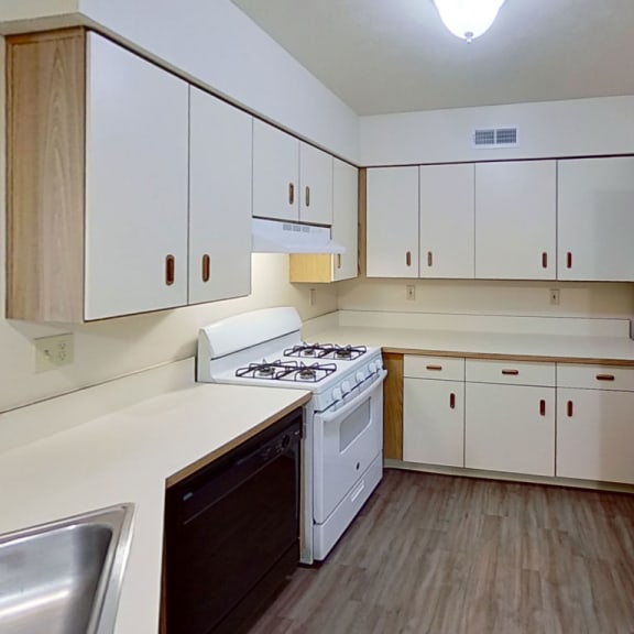 Thumbnail 6 of 9 an empty kitchen with white appliances and white cabinets at The Highlands Apartments, Elkhart, 46514