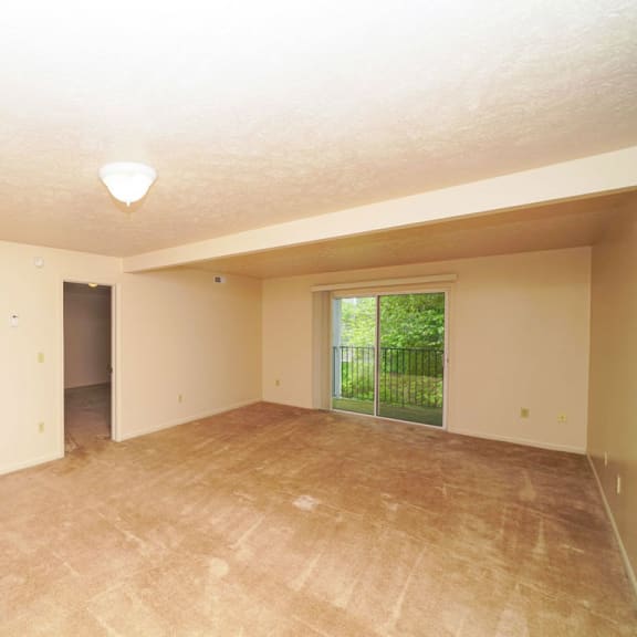 Thumbnail 4 of 13 A living room with access to a balcony at The Highlands Apartments, Elkhart, Indiana