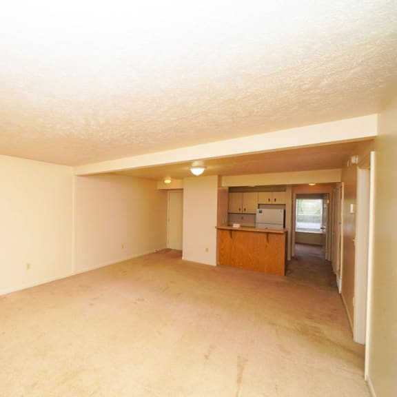 Thumbnail 5 of 13 an empty living room and kitchen at The Highlands Apartments, Elkhart, IN