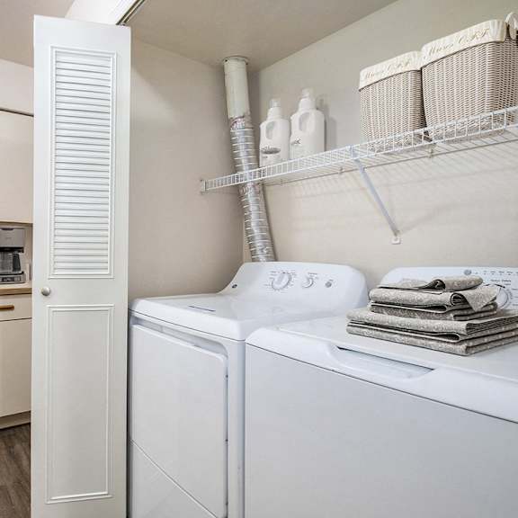 Thumbnail 7 of 9 A laundry area with a full size washer and dryer at The Highlands Apartments, Indiana