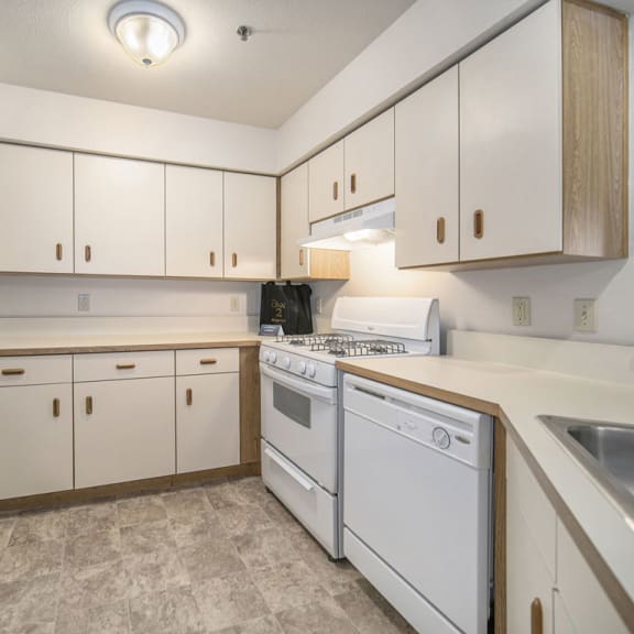 Thumbnail 6 of 10 a kitchen with white appliances and white cabinets  at Hurwich Farms Apartments, South Bend, IN