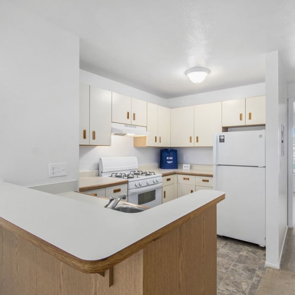 Thumbnail 7 of 17 a kitchen with white appliances at Hurwich Farms Apartments, Indiana