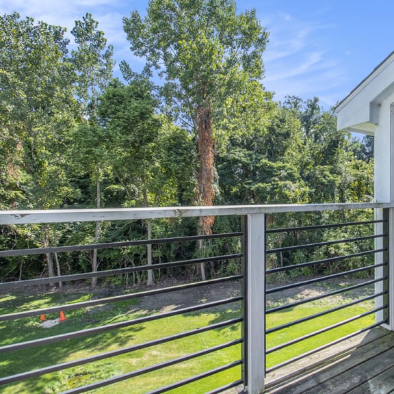 Thumbnail 4 of 17 a balcony with enclosed storage and a view of the woods at Hurwich Farms Apartments, Indiana