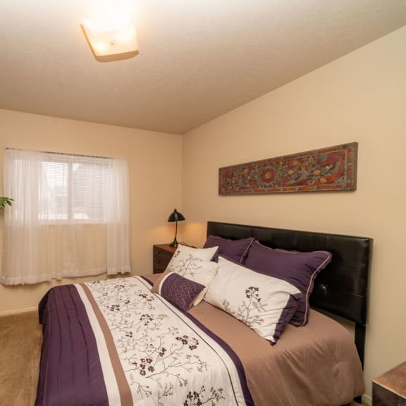 Thumbnail 8 of 9 a bedroom with a window at Indian Lakes Apartments, Mishawaka