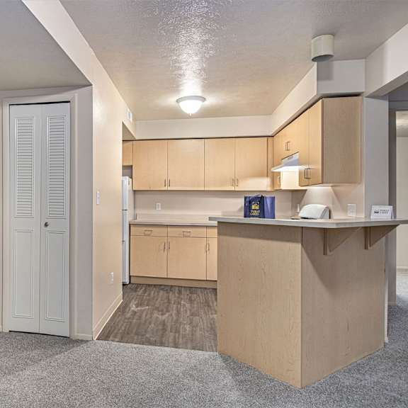 Thumbnail 4 of 7 A dining room and kitchen with a breakfast bar at Indian Lakes Apartments, Mishawaka, IN