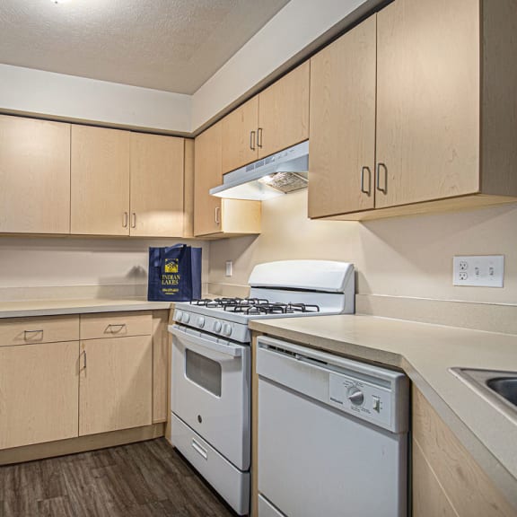 Thumbnail 4 of 6 a kitchen with white appliances and wooden cabinets at Indian Lakes Apartments, Mishawaka, 46545