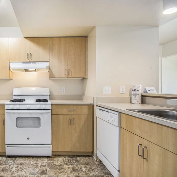 Thumbnail 7 of 13 a kitchen with white appliances and wooden cabinets  at Indian Lakes Apartments, Mishawaka, 46545