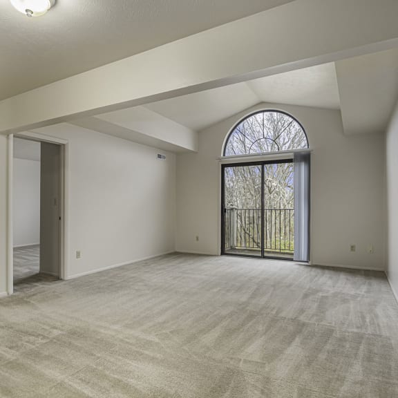 Thumbnail 3 of 13 the living room with a slider to a balcony at Indian Lakes Apartments, Mishawaka, Indiana