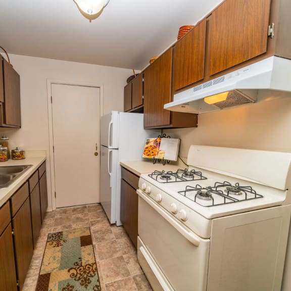 Thumbnail 7 of 10 A gallery style, traditional kitchen at Irish Hills Apartments, South Bend