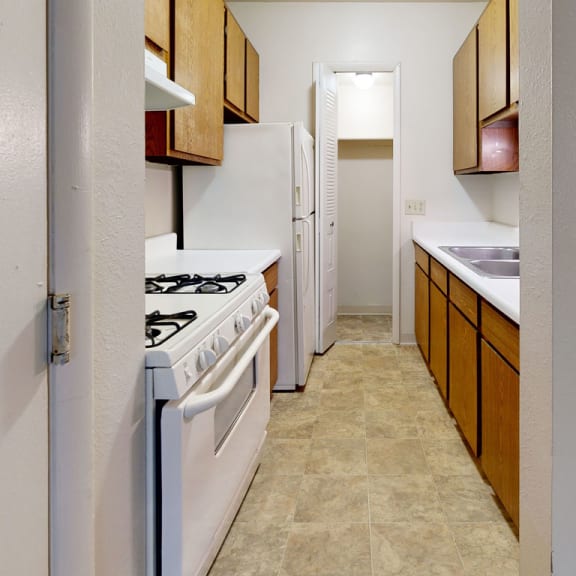 Thumbnail 7 of 9 a kitchen with a stove and a sink at Irish Hills Apartments, Indiana, 46614