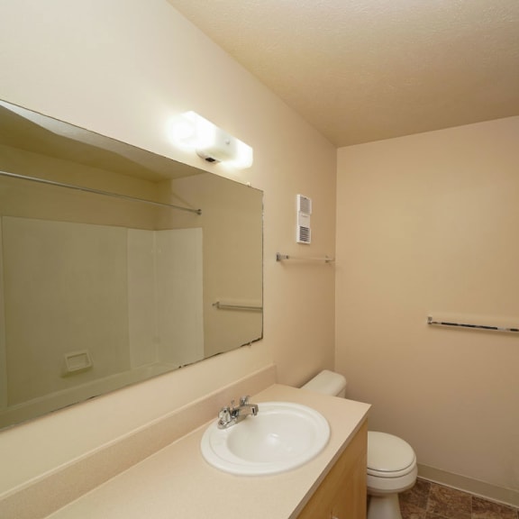 Thumbnail 10 of 14 A bathroom with a large vanity at Irish Hills Apartments, Indiana