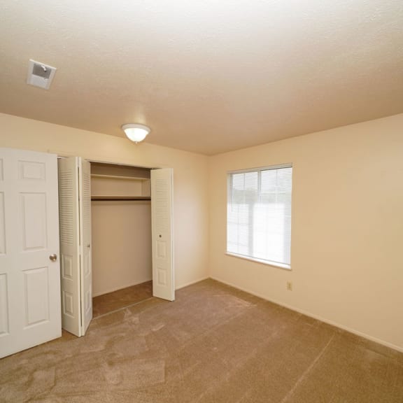 Thumbnail 14 of 14 A spacious bedroom with a closet at Irish Hills Apartments, South Bend