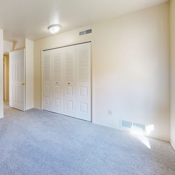 Thumbnail 13 of 14 a bedroom with a door to a closet at Irish Hills Apartments, South Bend, 46614