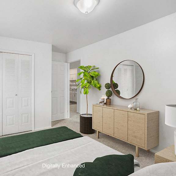 Thumbnail 9 of 10 A bedroom with a carpeted floor and a closet at Irish Hills Apartments, South Bend, 46614