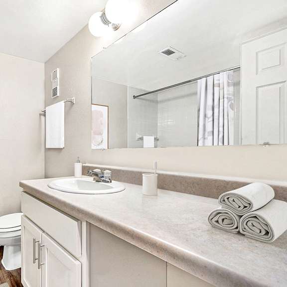 Thumbnail 9 of 13 An upgraded bathroom with white cabinetry at Irish Hills Apartments, South Bend, Indiana