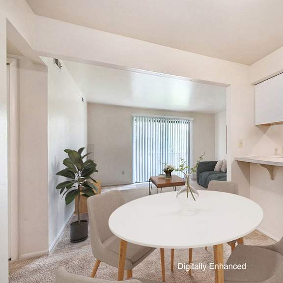 Thumbnail 4 of 14 A dining room with a white table, chairs, and a breakfast bar at Irish Hills Apartments, South Bend, Indiana