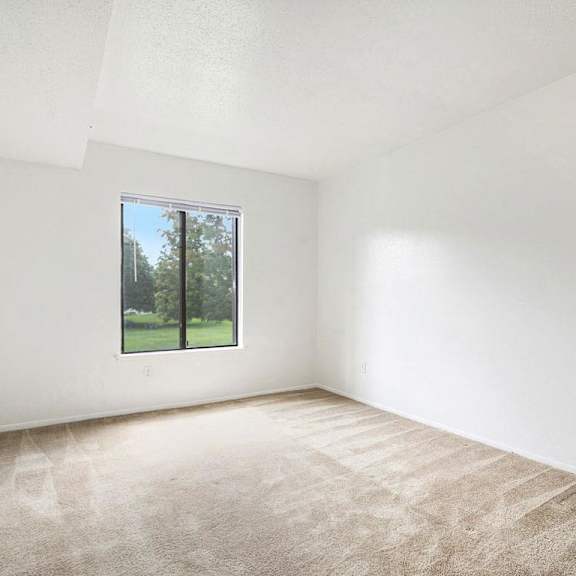 Thumbnail 10 of 10 A bedroom with a large window at Irish Hills Apartments, South Bend, 46614