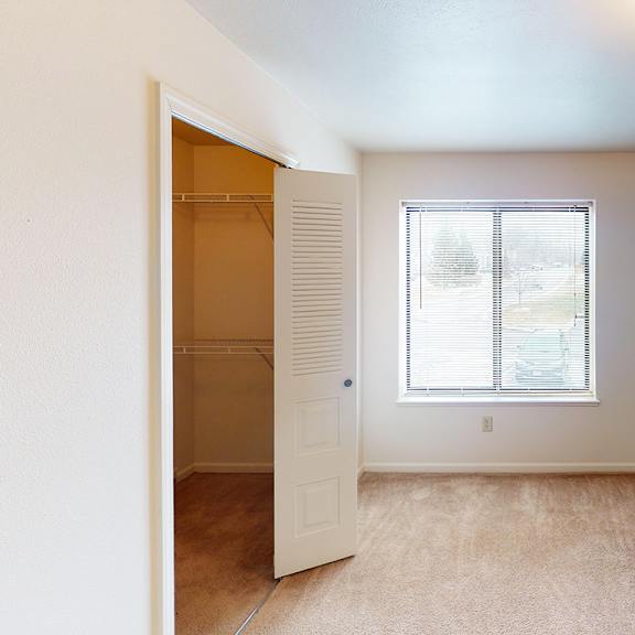Thumbnail 8 of 8 A bedroom with a window and a walk-in closet at Liberty Mills Apartments, Fort Wayne