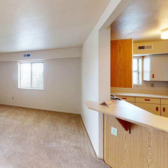 Thumbnail 4 of 8 An enlarged living room with a window and sliding glass door at Liberty Mills Apartments, Fort Wayne
