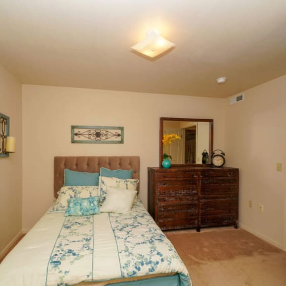 Thumbnail 9 of 10 bedroom with a bed and a dresser at Liberty Mills Apartments, Fort Wayne, IN, 46804