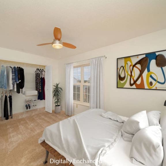 Thumbnail 8 of 10 a bedroom with a bed and a ceiling fan and a closet