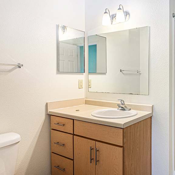 Thumbnail 21 of 21 A bathroom with a sink, mirror, and a shower at Limestone Creek Apartment Homes, Madison, AL