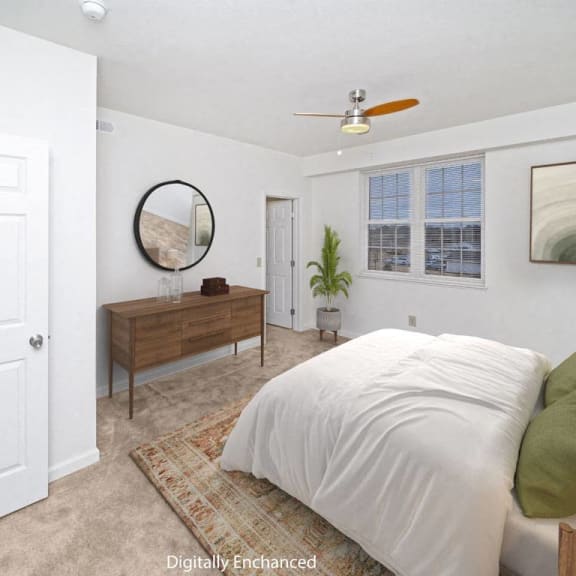 Thumbnail 10 of 13 a white bedroom with a bed and a mirror