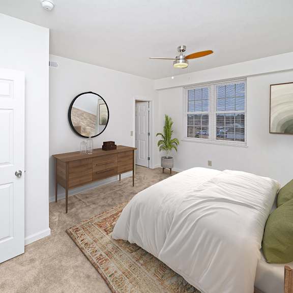 Thumbnail 15 of 21 a large bedroom with a bed and a ceiling fan at Limestone Creek Apartment Homes, Madison, AL
