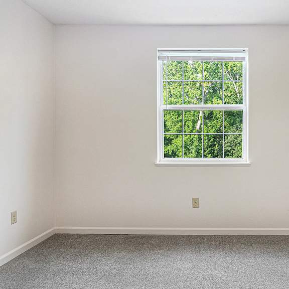 Thumbnail 19 of 21 A bedroom with a window and a carpeted floor at Limestone Creek Apartment Homes, Madison, AL
