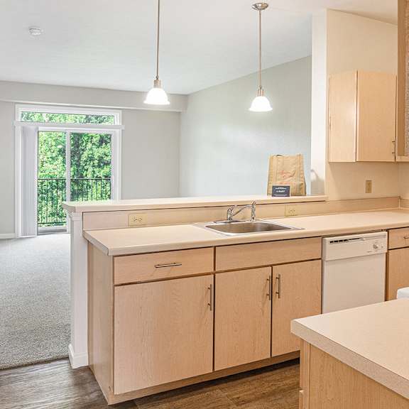 Thumbnail 8 of 21 A kitchen with wooden cabinets and a white appliances at Limestone Creek Apartment Homes, Madison, AL