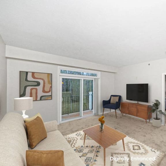 Thumbnail 3 of 13 a living room with a couch and a tv