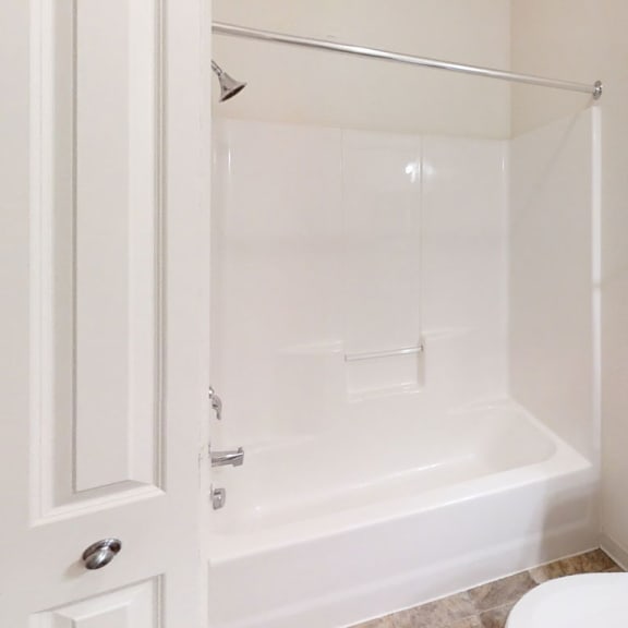 Thumbnail 9 of 12 a bathroom with a shower and a toilet  at Lynbrook Apartment Homes and Townhomes, Elkhorn, NE, 68022