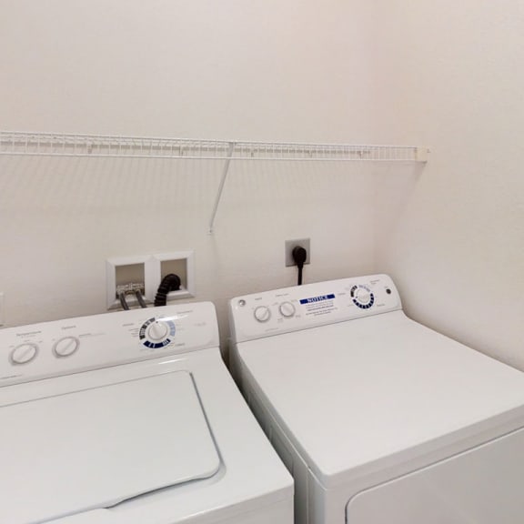 Thumbnail 8 of 12 a white washer and dryer in a white laundry room  at Lynbrook Apartment Homes and Townhomes, Elkhorn, NE, 68022