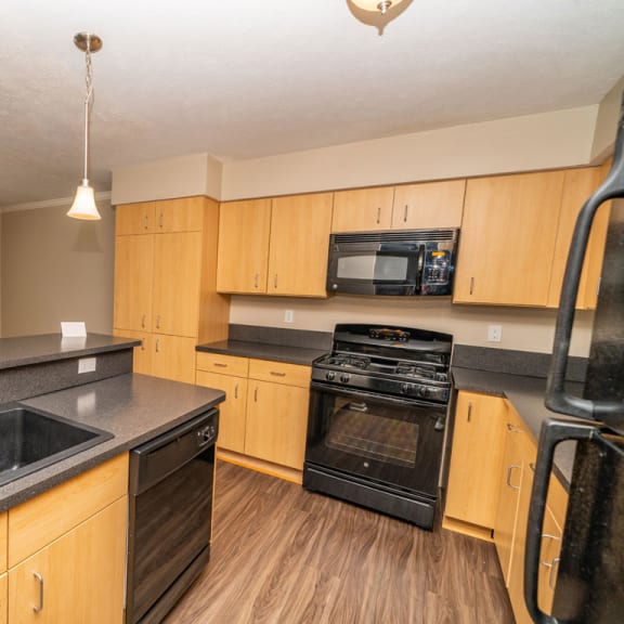 Thumbnail 6 of 15 A kitchen with black appliances at Lynbrook Apartments and Townhomes, Elkhorn, NE, 68022