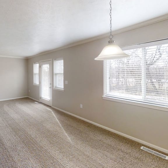 Thumbnail 4 of 15 A living room with plush carpeting at Lynbrook Apartments and Townhomes, Nebraska