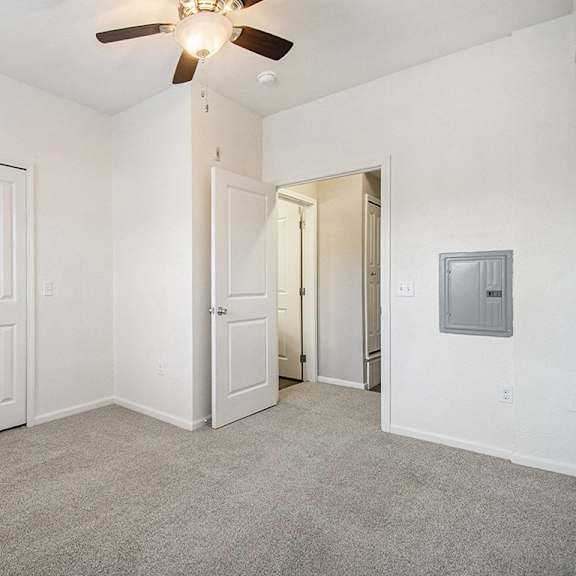 Thumbnail 14 of 15 A spacious bedroom with a ceiling fan and a large closet at Lynbrook Apartments and Townhomes, Elkhorn, NE, 68022